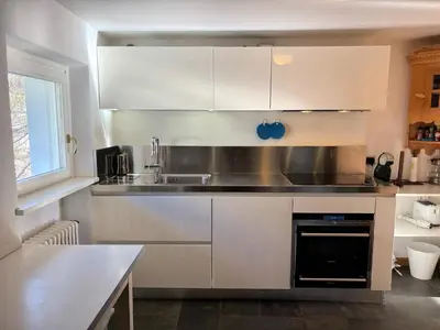 a white closet with white cabinets and drawers at Attico con vista sulle Tofane in Maion