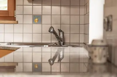 a kitchen sink with a faucet on top of it at Apartment Misalt in Castelrotto