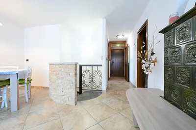 a living room with a fireplace and a table at Casa Lief in Mazzin