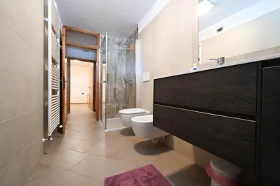 a bathroom with a toilet and a glass shower at Casa Lief in Mazzin