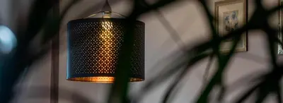 a black lamp hanging from a wall at Unterkirnhof in Schenna