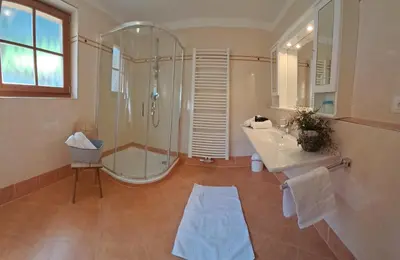 a bathroom with a shower and a sink and a tub at Unterkirnhof in Schenna