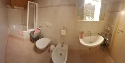 a bathroom with a toilet and a sink at Unterkirnhof in Schenna