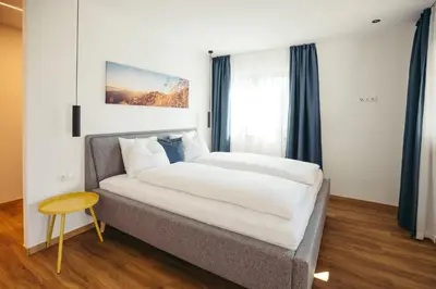 a bedroom with a bed and a table at Suite Mais in Merano