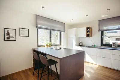 a kitchen with a island with two stools at Suite Mais in Merano