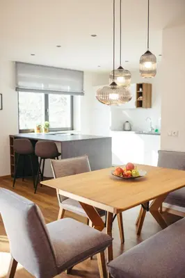a kitchen and dining room with a wooden table and chairs at Suite Mais in Merano