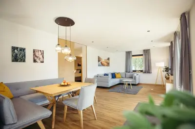 a living room with a couch and a table at Suite Mais in Merano