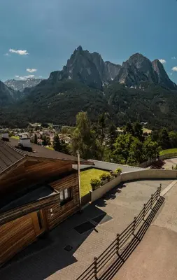 a view of mountains from a building with benches at Appartment Waldrand in Castelrotto