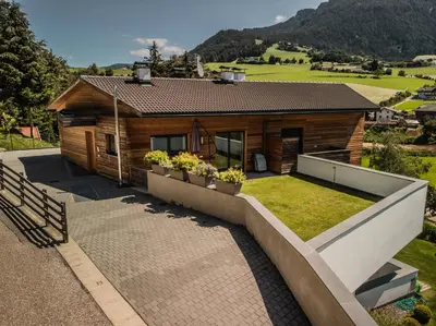a house with a garden in front of it at Appartment Waldrand in Castelrotto