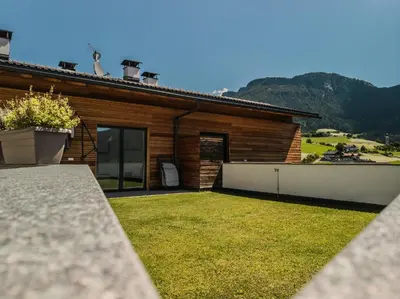 a house with a yard in front of it at Appartment Waldrand in Castelrotto
