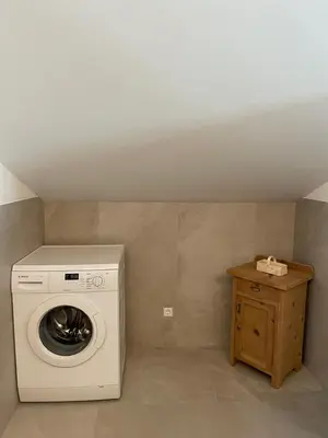a laundry room with a washing machine and a table at Ferienhaus Gann - Greit in Villandro