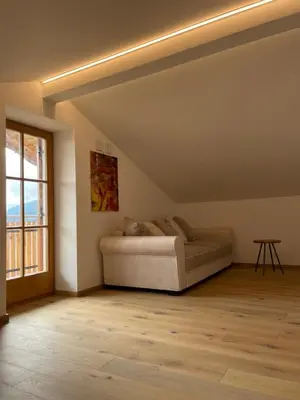 a living room with a couch and a window at Ferienhaus Gann - Greit in Villandro