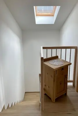 a small wooden table in a room with a skylight at Ferienhaus Gann - Greit in Villandro