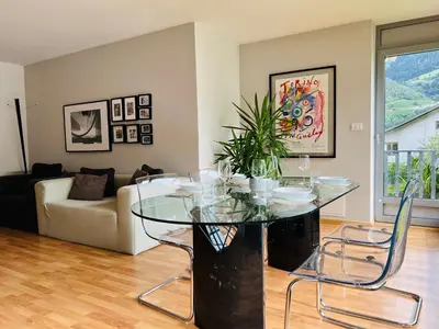 a dining room with a table and white chairs at Villa Maria in Rablà