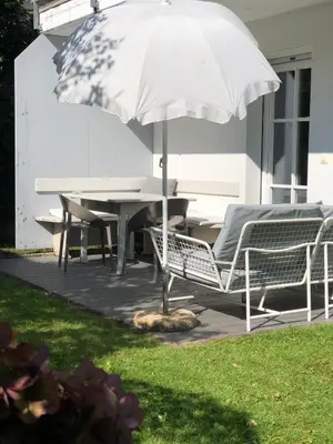 a table and chairs and an umbrella on a patio at Villa Maria in Rablà