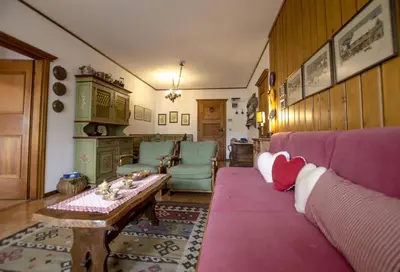 a living room with a purple couch and a table at Villa Aurora in Pocol