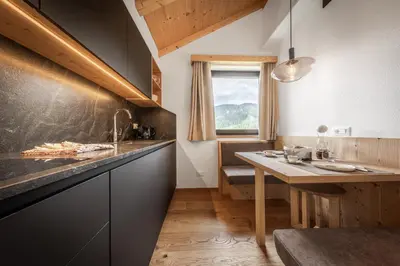 a bedroom with two beds and a window at Apartment Ciasa Laoi in San Cassiano