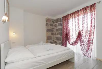 a white bed in a room with a window at Apartment Residence Veronika in Ora/Auer