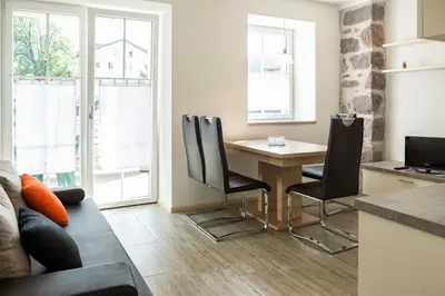 a kitchen and living room with a table and chairs at Apartment Residence Veronika in Ora/Auer