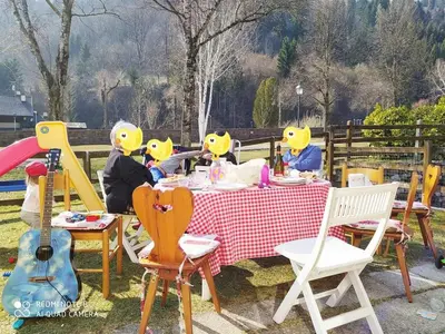 a group of people in rubber ducky hats sitting at a table at La casa dello scoiattolo primierotto in Tonadico