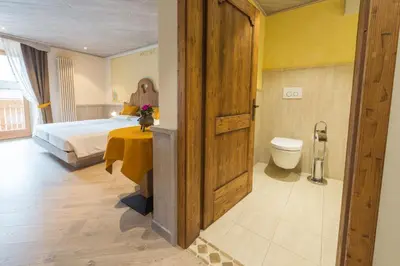 a bedroom with a bed and a toilet in a room at Agritur Casa Fabri in Coredo