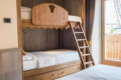 a bunk bed with a ladder in a room at Agritur Casa Fabri in Coredo