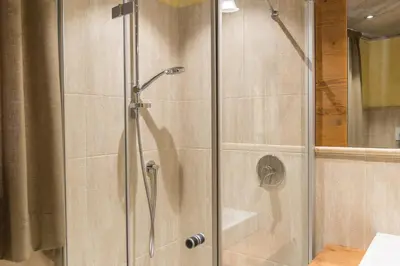 a shower with a glass door in a bathroom at Agritur Casa Fabri in Coredo