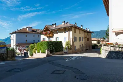 a house on a street in a town at Agritur Casa Fabri in Coredo
