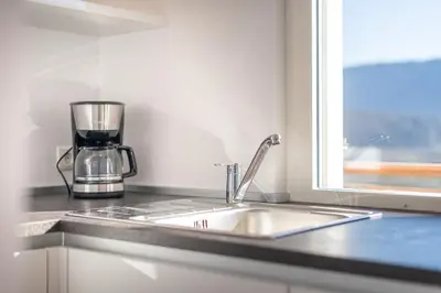 a kitchen counter with a sink and a window at Residence 1963 - Apartments in Termeno