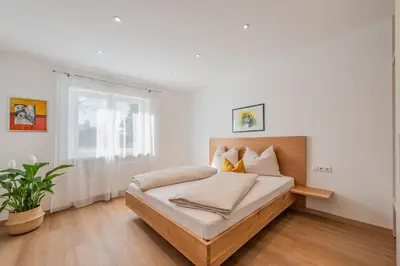 a bedroom with a bed and a window at Residence 1963 - Apartments in Termeno