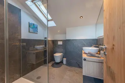 a bathroom with a shower and a sink and a toilet at Residence 1963 - Zimmer in Termeno