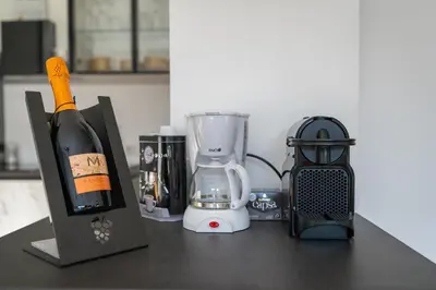 a counter top with a blender and a bottle of wine at Ausblick Kleinjuwel mit Panoramablick + Garage in Merano