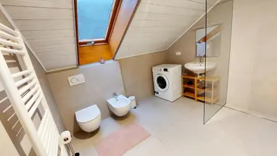 a small bathroom with a toilet and a sink at Suite Castel MeranO - panorama terrace and pool in Merano