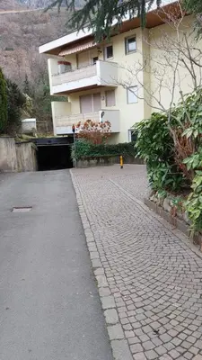 a brick road in front of a building at Suite Castel MeranO - panorama terrace and pool in Merano