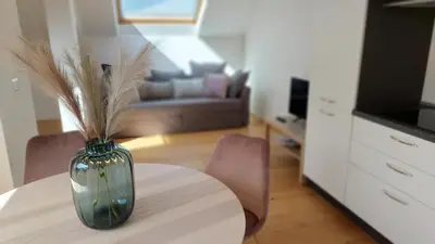 a vase sitting on a table in a living room at Suite Castel MeranO - panorama terrace and pool in Merano