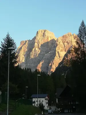 a mountain in the distance with a house in front at Dolomites Holidays in Selva di Cadore