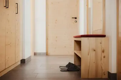 a room with a wooden counter and a hallway at Chalet Lärchenhof in Colfosco