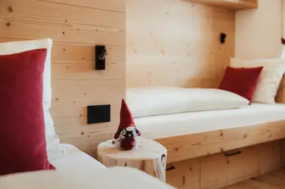 a room with a bed with a santa hat on a table at Chalet Lärchenhof in Colfosco