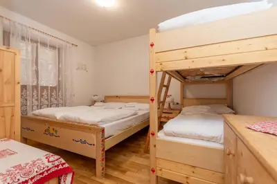 a bedroom with two bunk beds and a window at La Casa di Carlotta in Alleghe
