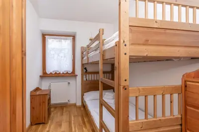 a room with two bunk beds and a window at La Casa di Carlotta in Alleghe
