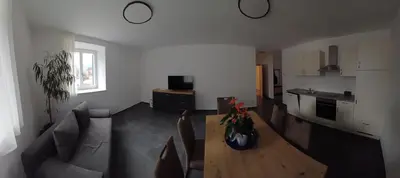 a living room with a couch and a table at Lanziner Apartments in Egna