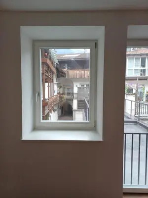a window with a view of a building at Lanziner Apartments in Egna