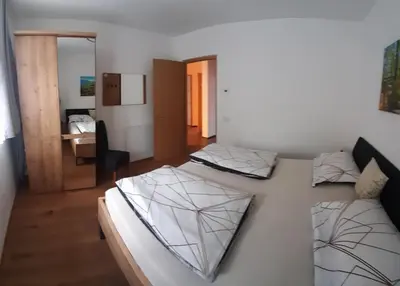 a bedroom with two beds in a room at Lanziner Apartments in Egna