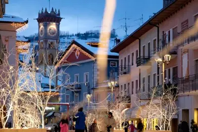 a clock tower in a town with christmas lights at Oasi Verde - Alpine Stay Apartments in Carano
