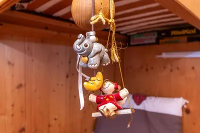 a group of stuffed animals hanging from a ceiling at Appartamento Sandra - Molino in Falcade