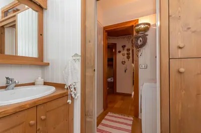 a bathroom with a sink and a mirror at Appartamento Sandra - Molino in Falcade