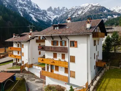 a building with a view of mountains at Appartamento Sandra - Molino in Falcade