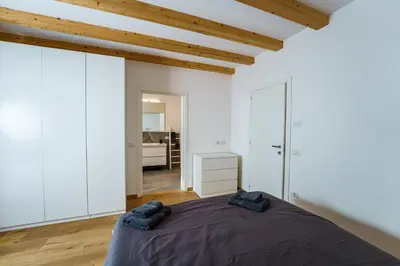 a bedroom with a large bed in a room with white walls at Casa Corradini by Go New Location in Carano