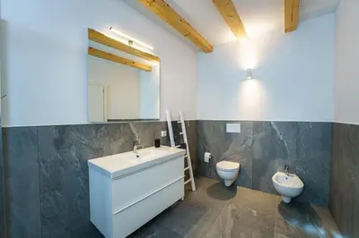 a bathroom with a sink and a toilet at Casa Corradini by Go New Location in Carano