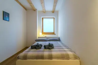a bedroom with a bed with two shoes on it at Casa Corradini by Go New Location in Carano